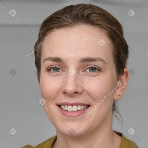 Joyful white young-adult female with medium  brown hair and grey eyes