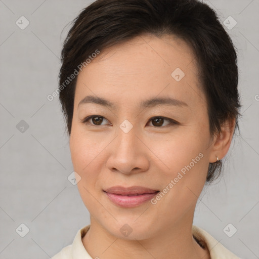 Joyful asian young-adult female with short  brown hair and brown eyes