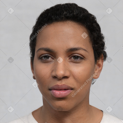 Joyful latino young-adult female with short  black hair and brown eyes