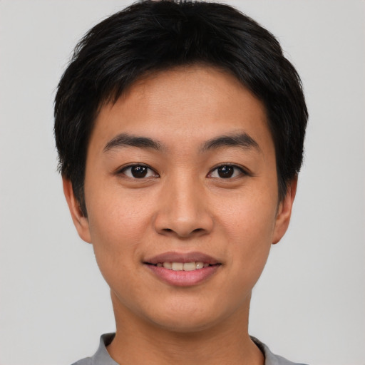 Joyful asian young-adult male with short  black hair and brown eyes