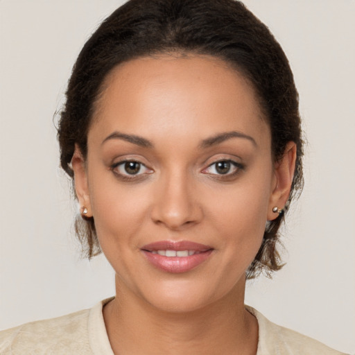 Joyful latino young-adult female with medium  brown hair and brown eyes