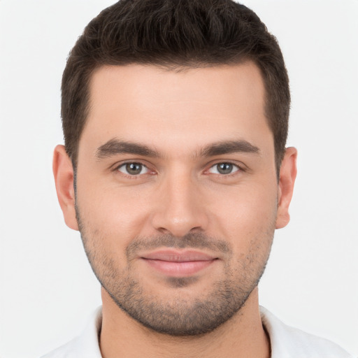 Joyful white young-adult male with short  brown hair and brown eyes