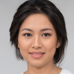 Joyful asian young-adult female with medium  brown hair and brown eyes