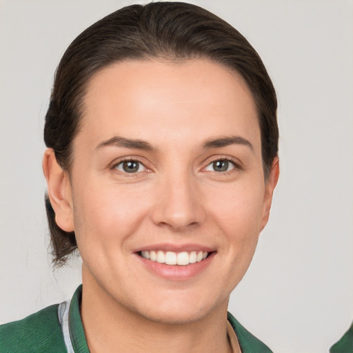 Joyful white young-adult female with short  brown hair and grey eyes