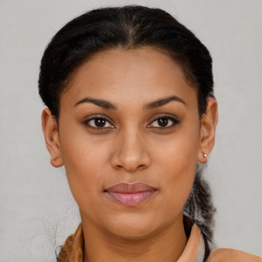 Joyful black young-adult female with short  brown hair and brown eyes