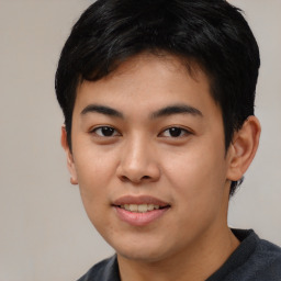 Joyful asian young-adult male with short  black hair and brown eyes