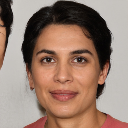 Joyful white adult female with medium  brown hair and brown eyes