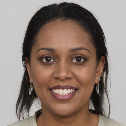 Joyful black young-adult female with medium  brown hair and brown eyes