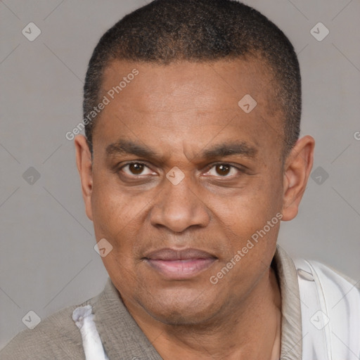 Joyful latino adult male with short  brown hair and brown eyes