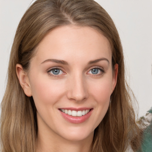 Joyful white young-adult female with long  brown hair and grey eyes