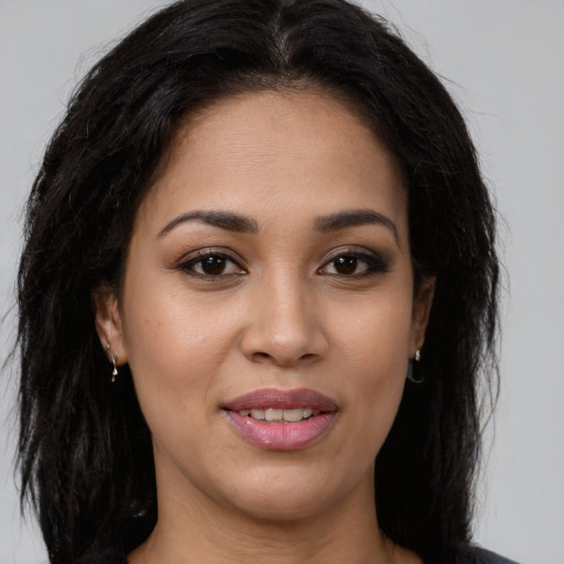 Joyful latino young-adult female with long  brown hair and brown eyes