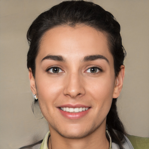 Joyful white young-adult female with short  black hair and brown eyes