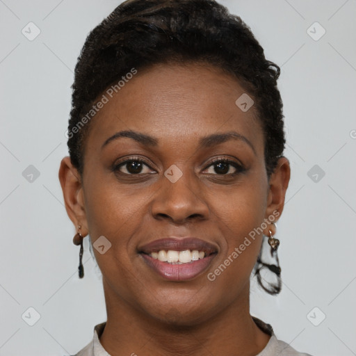 Joyful black young-adult female with short  brown hair and brown eyes