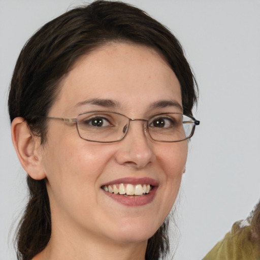 Joyful white young-adult female with medium  brown hair and grey eyes