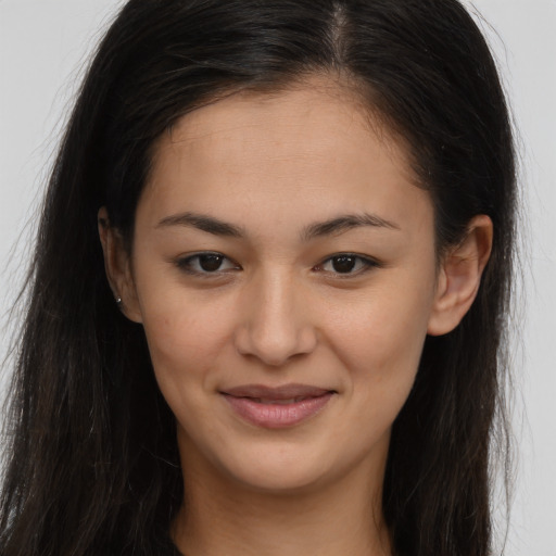 Joyful latino young-adult female with long  brown hair and brown eyes