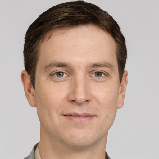 Joyful white adult male with short  brown hair and grey eyes