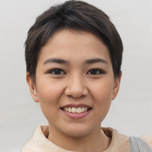 Joyful asian young-adult female with short  brown hair and brown eyes