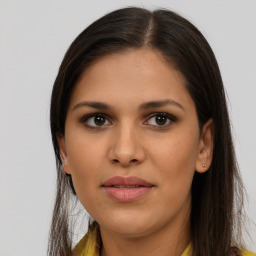 Joyful latino young-adult female with long  brown hair and brown eyes