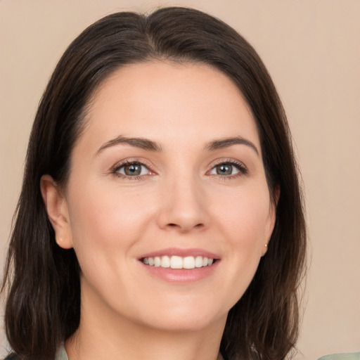 Joyful white young-adult female with medium  brown hair and brown eyes