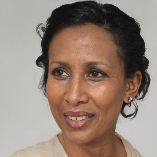 Joyful black adult female with medium  black hair and brown eyes