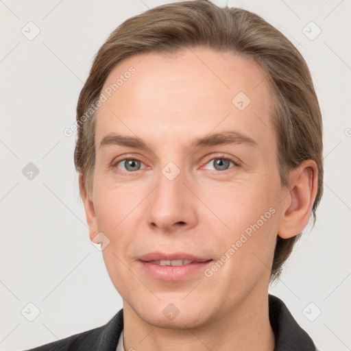 Joyful white adult male with short  brown hair and grey eyes