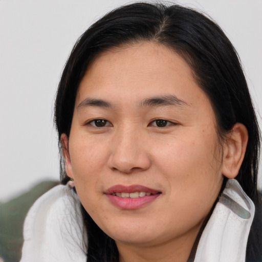 Joyful asian young-adult female with medium  brown hair and brown eyes