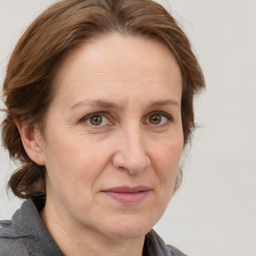 Joyful white adult female with medium  brown hair and grey eyes