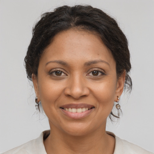 Joyful latino adult female with medium  brown hair and brown eyes