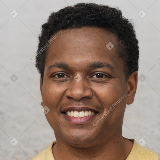 Joyful latino young-adult male with short  brown hair and brown eyes