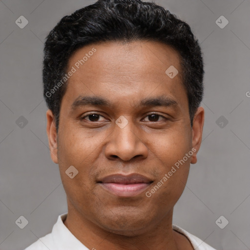 Joyful latino adult male with short  black hair and brown eyes