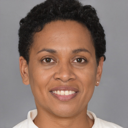 Joyful black adult female with short  brown hair and brown eyes