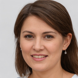 Joyful white young-adult female with medium  brown hair and grey eyes