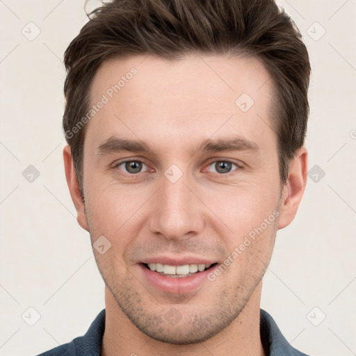 Joyful white young-adult male with short  brown hair and grey eyes