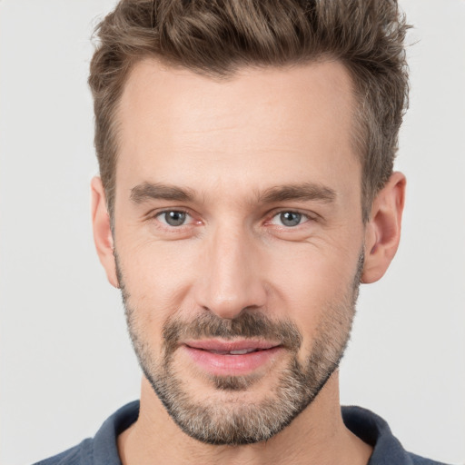 Joyful white adult male with short  brown hair and brown eyes