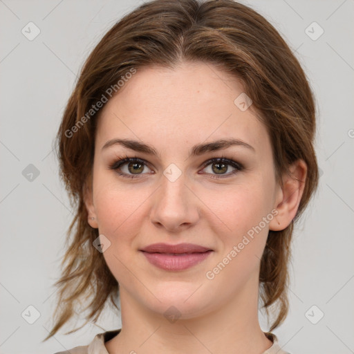 Joyful white young-adult female with medium  brown hair and green eyes