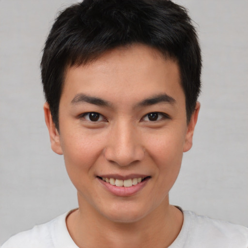 Joyful asian young-adult male with short  brown hair and brown eyes