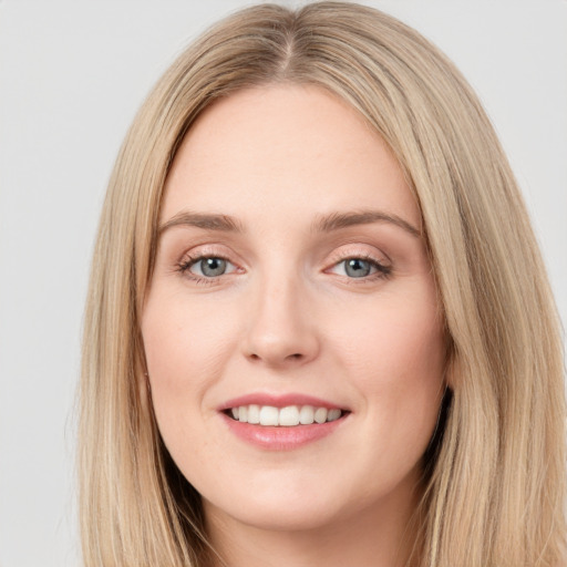 Joyful white young-adult female with long  brown hair and green eyes