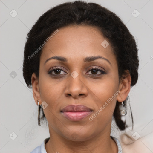 Joyful black adult female with short  brown hair and brown eyes