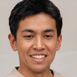 Joyful asian young-adult male with short  black hair and brown eyes