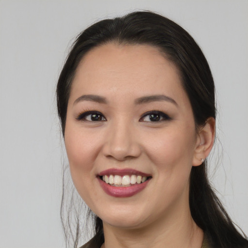 Joyful white young-adult female with long  black hair and brown eyes