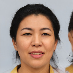 Joyful asian adult female with medium  brown hair and brown eyes