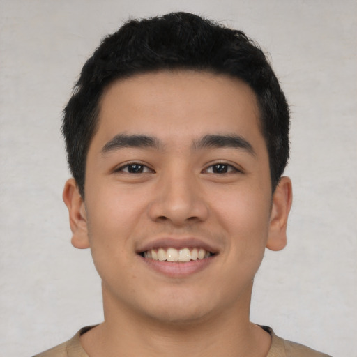 Joyful asian young-adult male with short  black hair and brown eyes