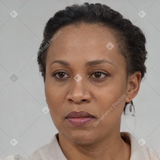Joyful black adult female with short  brown hair and brown eyes
