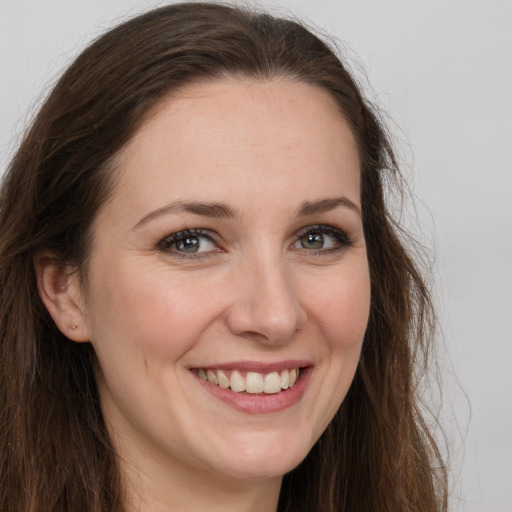 Joyful white young-adult female with long  brown hair and grey eyes