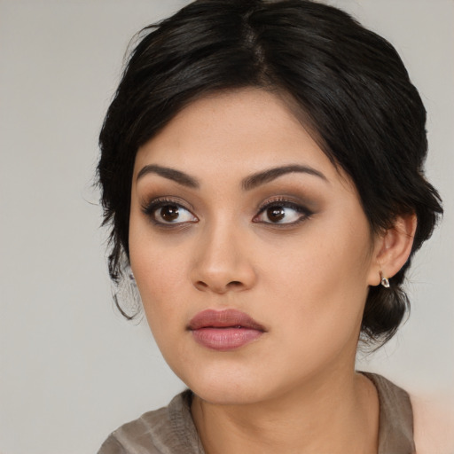 Neutral latino young-adult female with medium  black hair and brown eyes