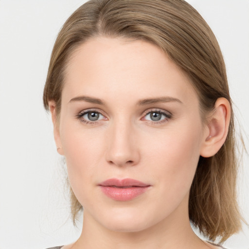 Joyful white young-adult female with long  brown hair and grey eyes