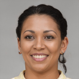 Joyful latino adult female with short  brown hair and brown eyes