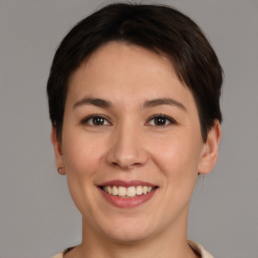 Joyful white young-adult female with short  brown hair and brown eyes