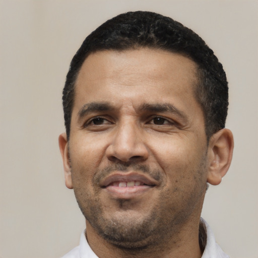 Neutral latino adult male with short  black hair and brown eyes