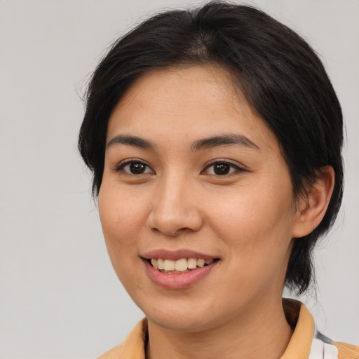 Joyful asian young-adult female with medium  brown hair and brown eyes